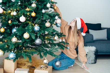 Teenage girl decorates the Christmas tree, a Holiday Photo by Olena Rudo