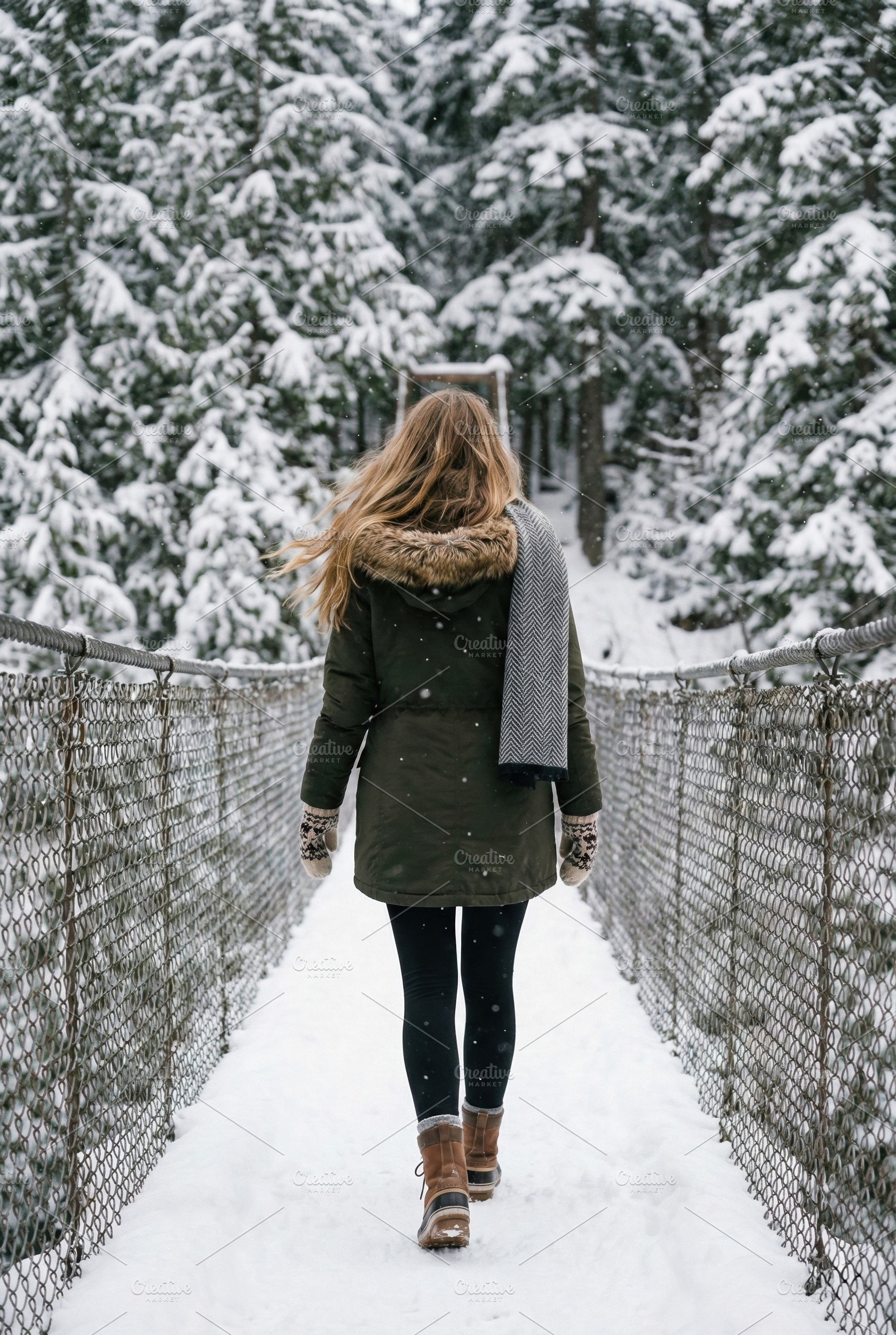 Woman Walking Snow-Covered Bridge, a Person Photo by Virgo Studio