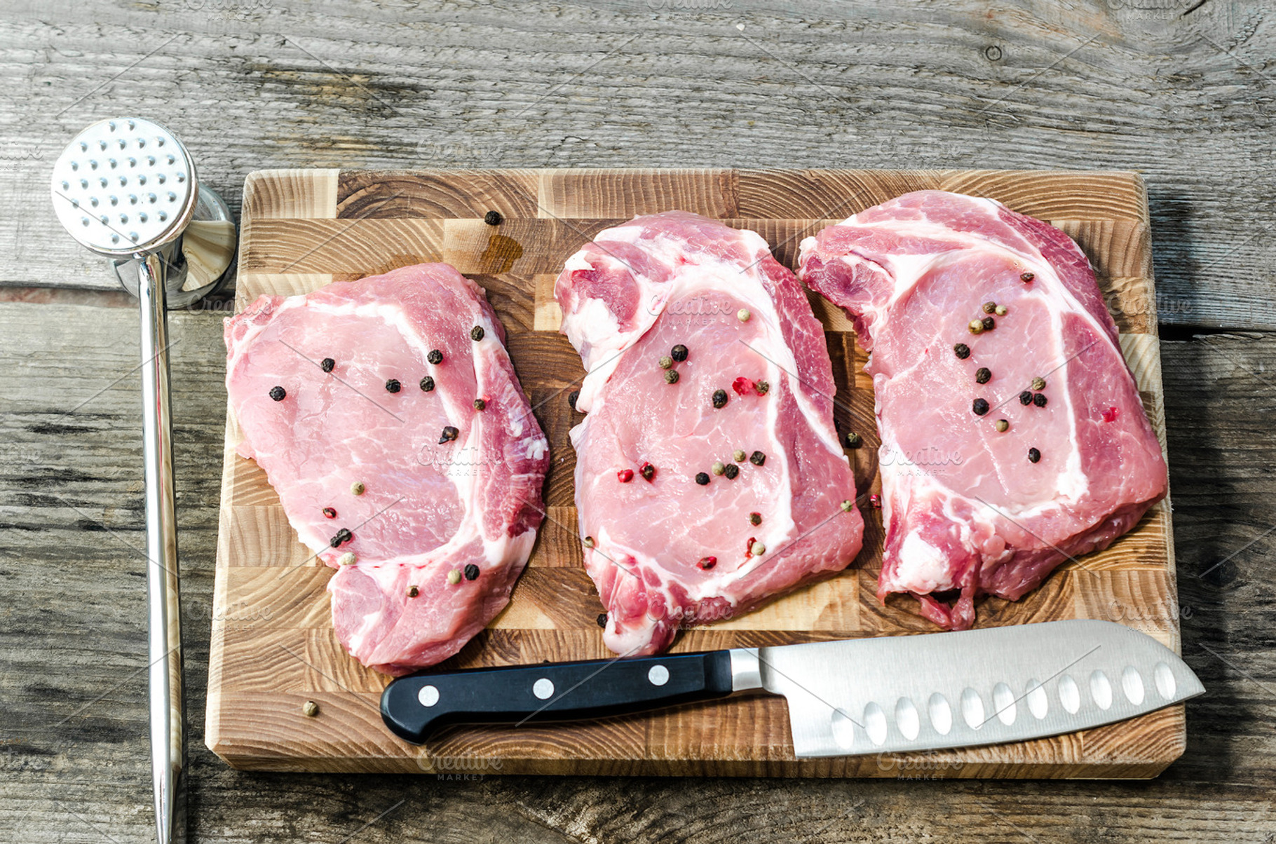 Raw pork steaks containing barbecue, cooking, and diet, a Food & Drink Photo by Alexander Prokopenko