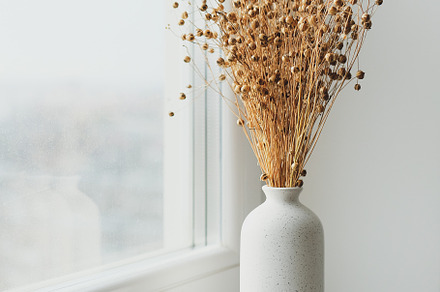 Vase of dried flax linum on windowsill. Nordic style home interior decor., a Holiday Photo by photoguns