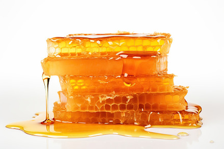 Honeycomb and honey on white background, a Food & Drink Photo by AlyaAnd