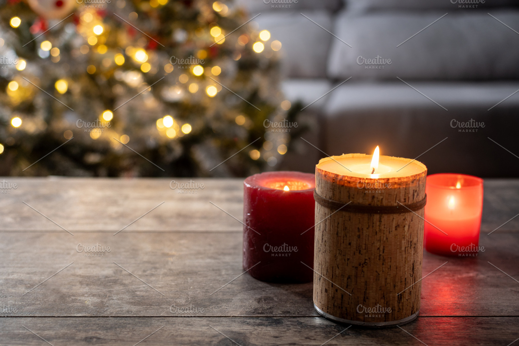 Red Christmas candles with holiday lights and tree in background, a Food & Drink Photo by etorres69