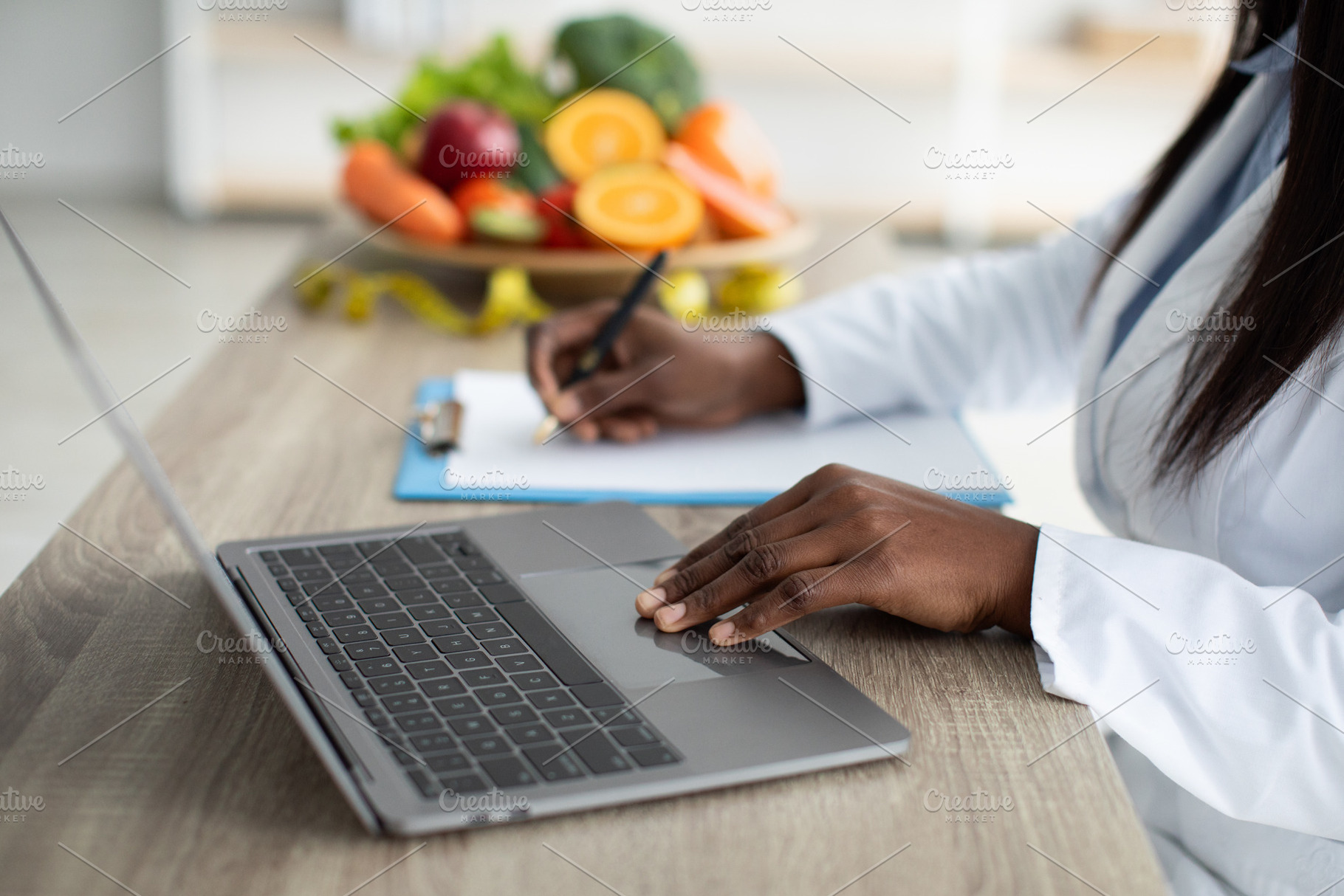 Working process. African american dietitian creating diet plan for patient or c, a Person Photo by Prostock-Studio