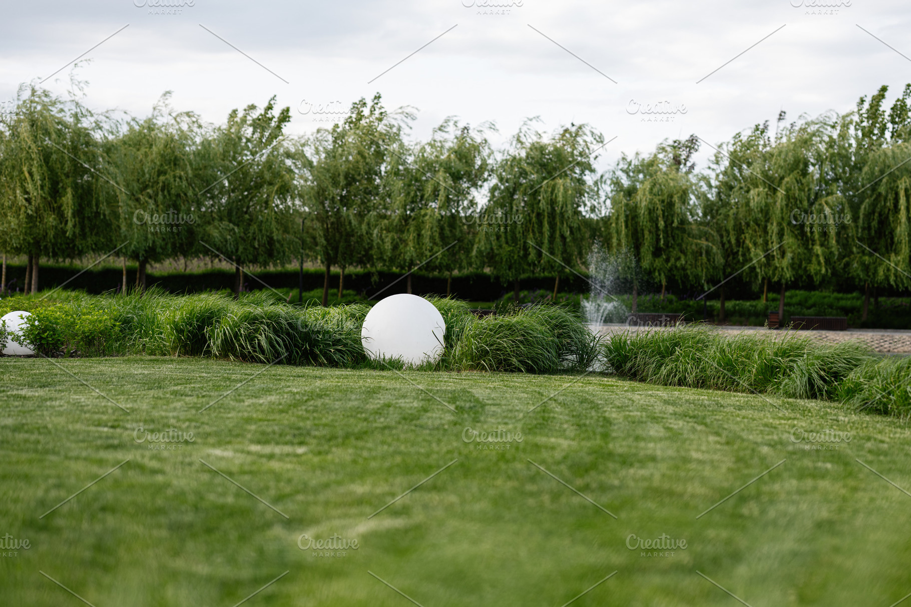 Serene garden setting featuring manicured landscape with decorative foliage and, a Photo by AS photostudio