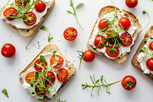 Sandwich with cream cheese, microgreens and tomatoes on white background, a Food & Drink Photo by AlyaAnd