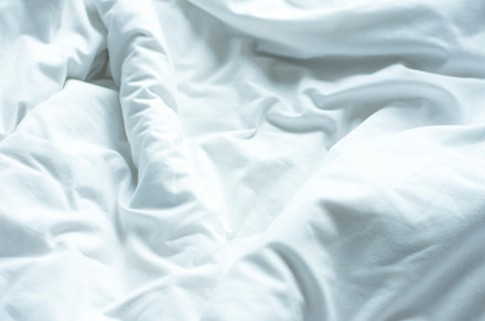 White sheets, wrinkled duvets.