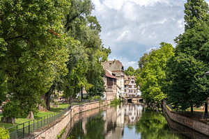 Canal and trees in Petite France Strasbourg, France, an Architecture Photo by GoodGoods