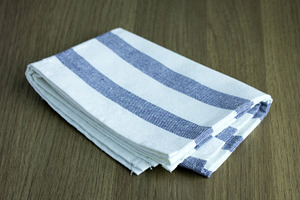 Folded napkin containing napkin, fabric, and fashion