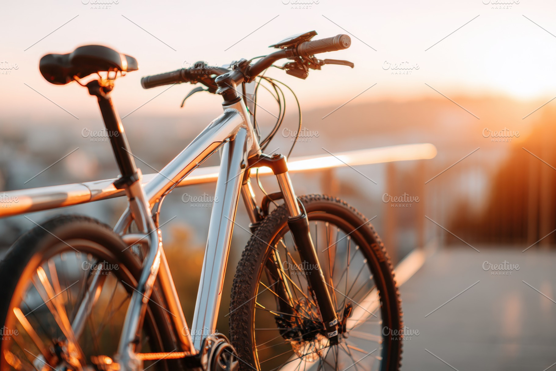 Silver mountain bike at sunset, a Transportation Photo by AlyaAnd