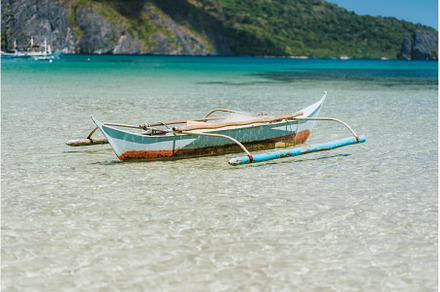 Boat on blue shallow ocean water. El, a Nature Photo by Igor Tichonow