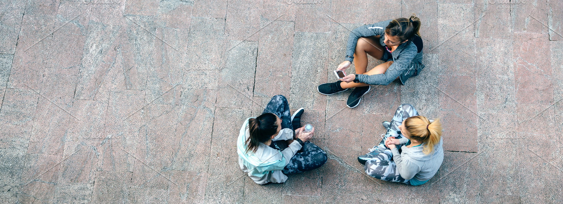 Women friends runners relaxing sitting on the floor after training, a Sports & Recreation Photo by davidpereiras