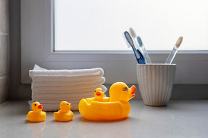 Family of yellow rubber ducks in a r, an Abstract Photo by Imaginarium