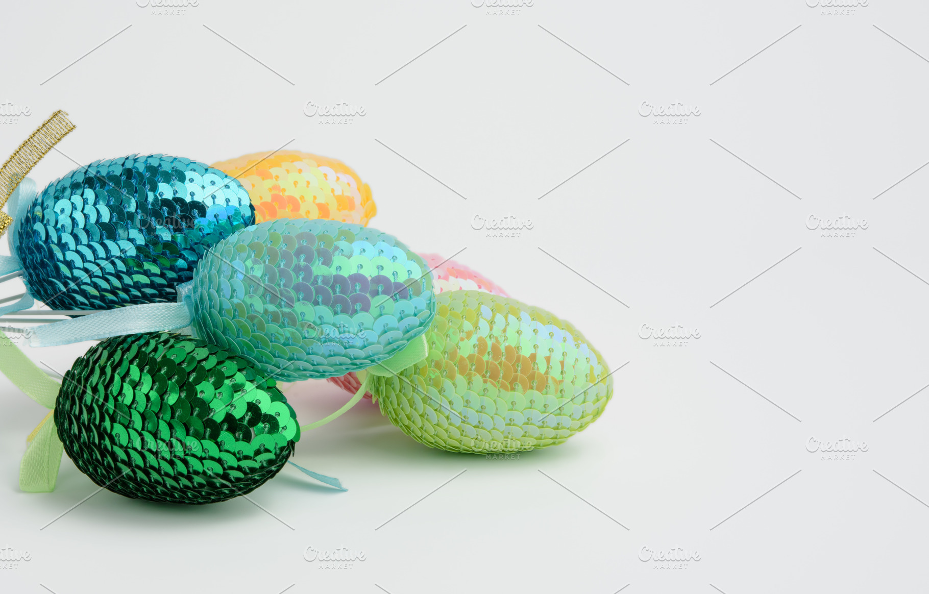 Decorative Easter eggs with sequins on a white background, a Holiday Photo by ndanko
