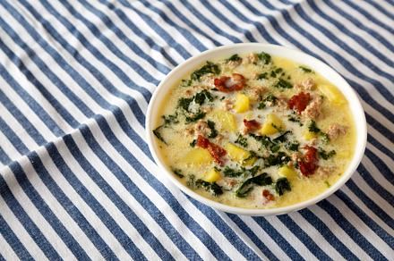 Homemade Zuppa Toscana with Kale and Bread in a white bowl, low, a Food & Drink Photo by LiudmylaChuhunova