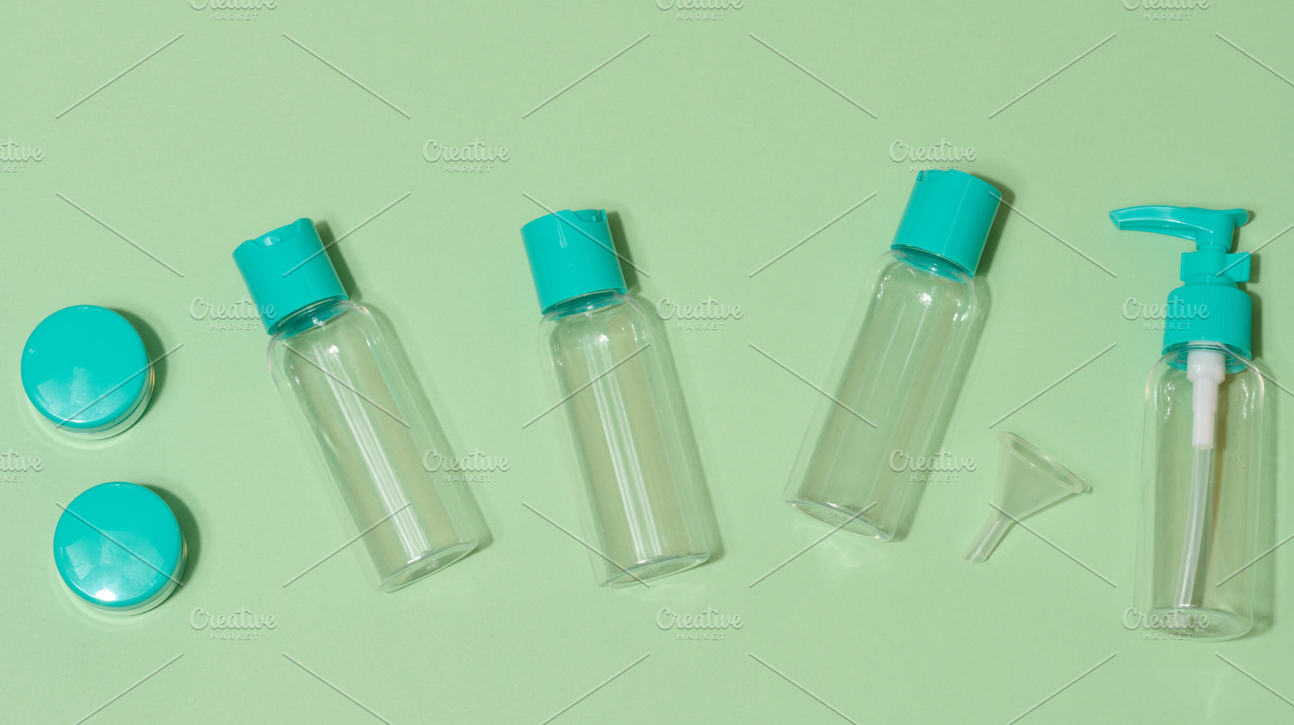 Top view of set of five transparent cosmetic bottles and two rou, a Health & Medical Photo by ndanko
