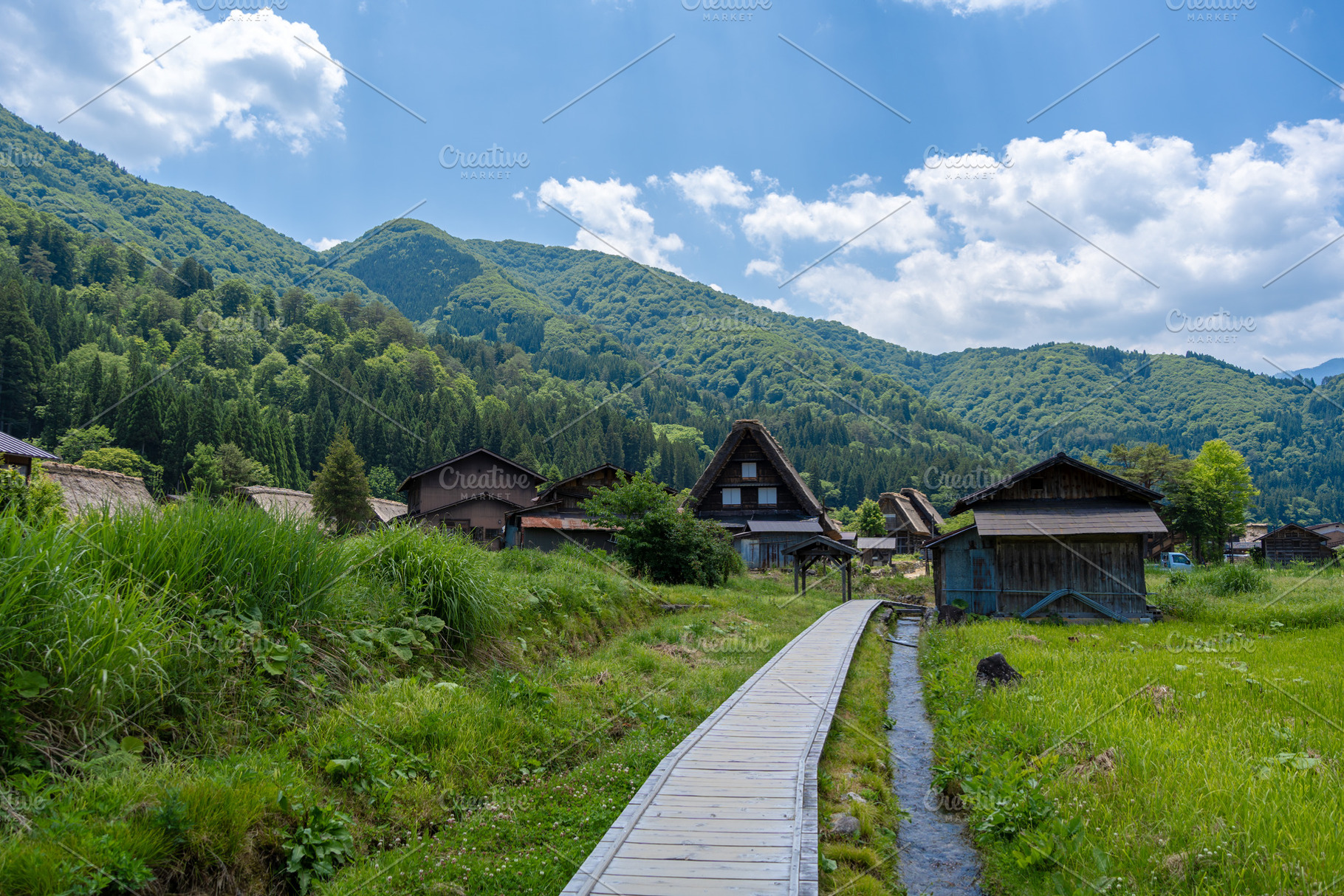 Wooden path crossing traditional village of Shirakawa-go in Japa, an Architecture Photo by GoodGoods