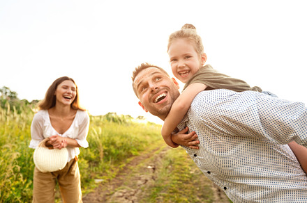 Happy family playing together in the, a Photo by Prostock-Studio