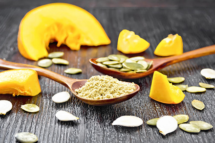 Flour and seeds pumpkin in spoons
