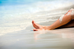 Woman's Legs on Sandy Beach, a Person Photo by THP Creative