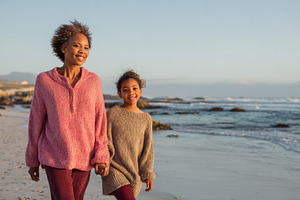 Mom and daughter walk beach, a Photo by Beautiful things