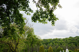 Family exploring a serene countryside with greenery and a charming white chapel, a Person Photo by AS photostudio