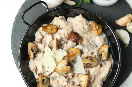 Concept of tasty food with risotto with mushrooms, top view, a Food & Drink Photo by AtlasStudio