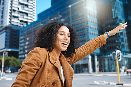 Black woman, city and stop taxi with smile, sunshine and urban adventure on sidewalk in summer. Girl, outdoor and street in metro for transport, bus or ride service with happiness, holiday or travel, a Photo by Peopleimages.com