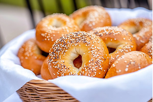 Fresh sesame seed bagels in wicker, a Food & Drink Photo by Lermont51