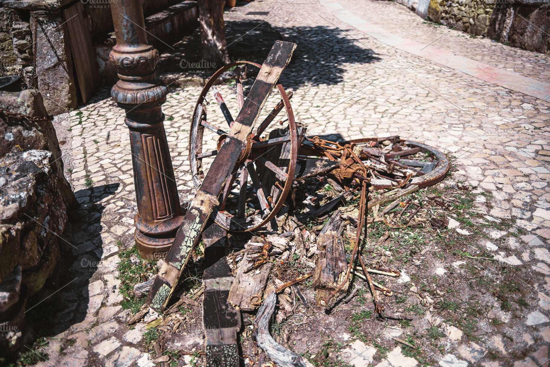 Broken cart on cobblestone street, a Photo by SkyNext