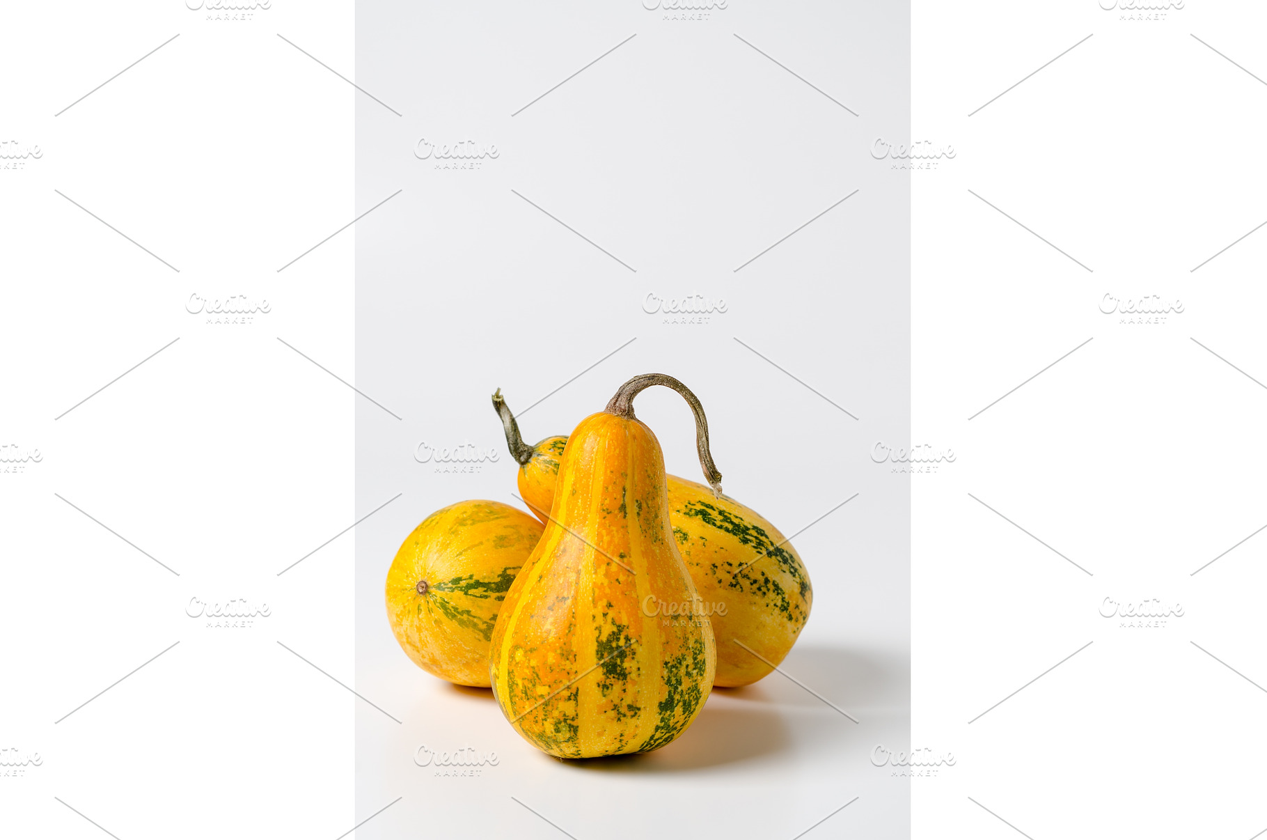 Three yellow pumpkins isolated on, a Food & Drink Photo by JeanBet