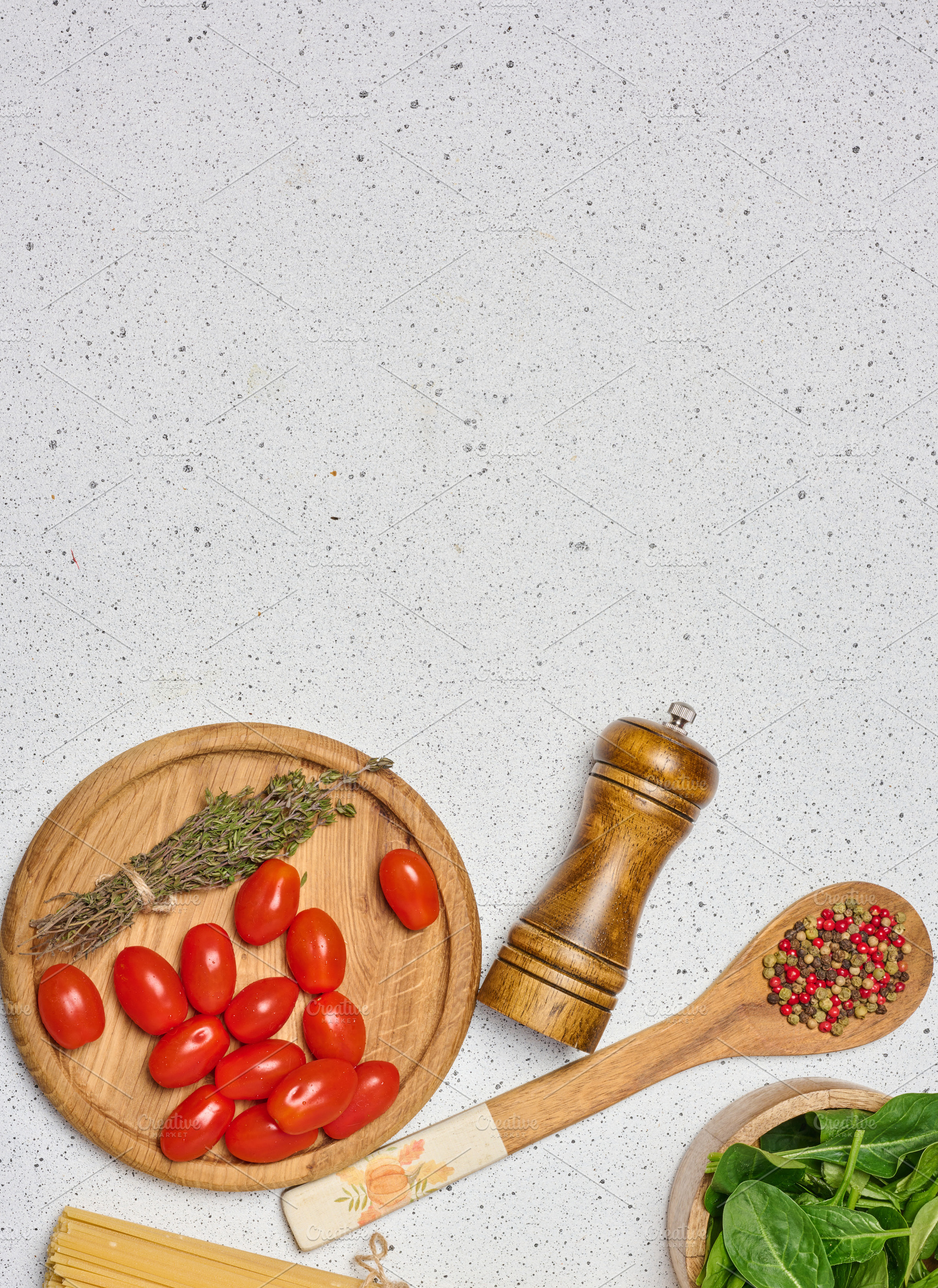 A flat lay shot of a wooden bowl with spinach, cherry tomatoes o, a Food & Drink Photo by ndanko