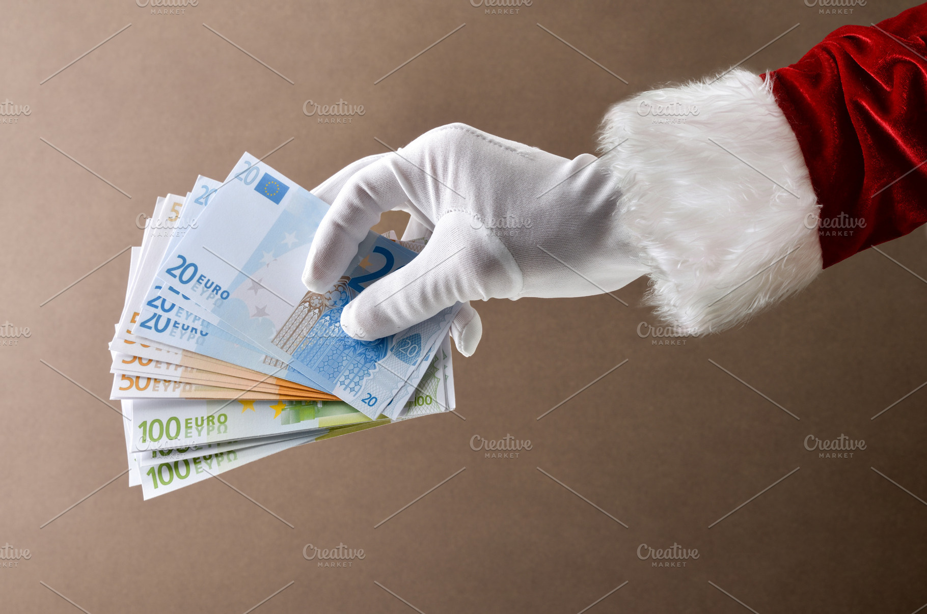 Santa Claus with pile of euro banknotes isolated on brown, a Holiday Photo by Davizro's Market