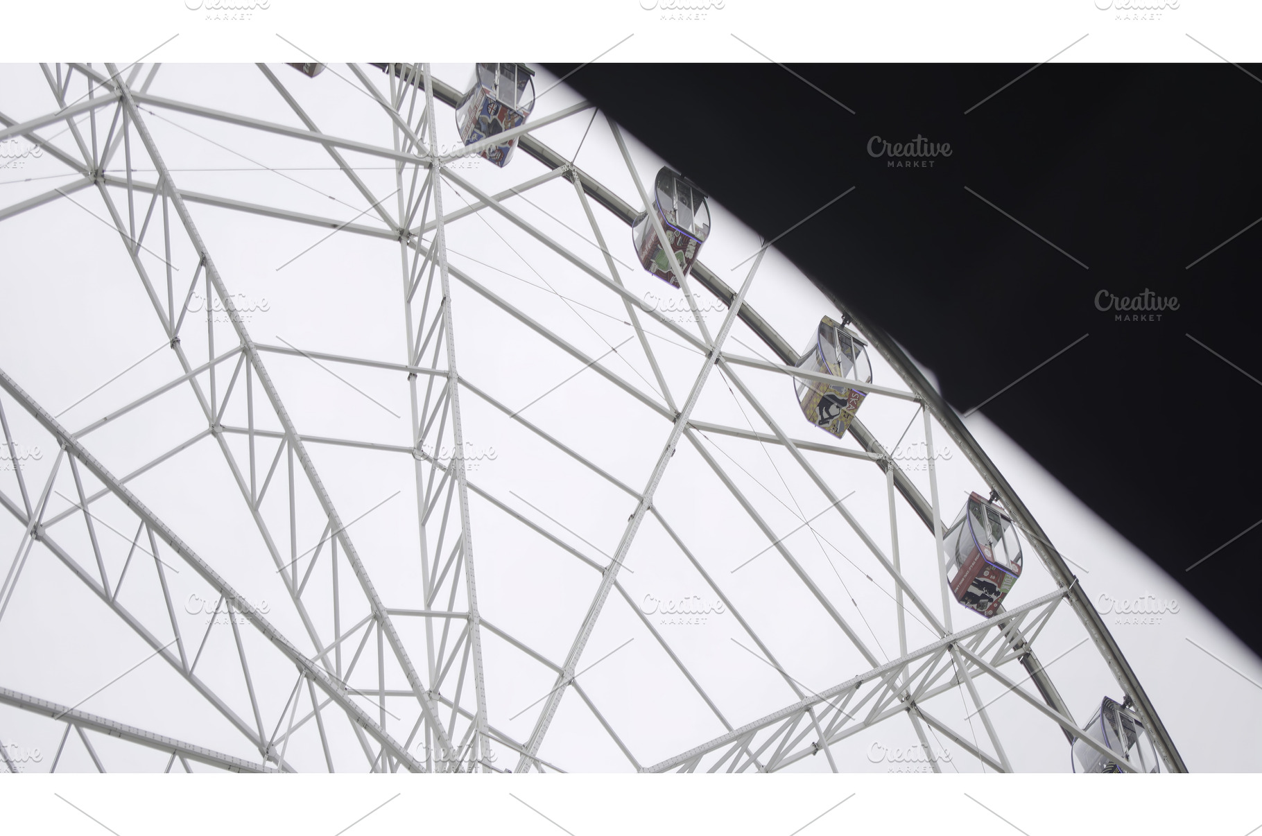 Ferris wheel rotating under cloudy, a Sports & Recreation Photo by Media Whale Stock