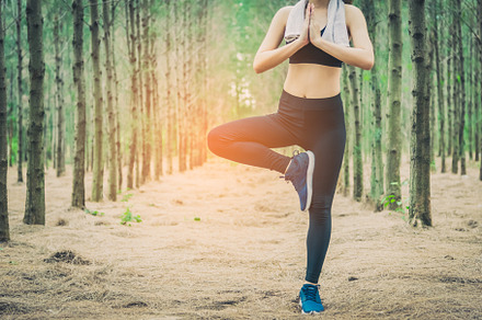 Beautiful Asian young woman standing and doing yoga in forest. E, a Sports & Recreation Photo by Ministocker