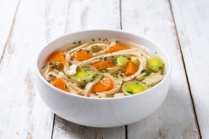 Homemade chicken soup in white bowl with carrots and celery, a Food & Drink Photo by etorres69
