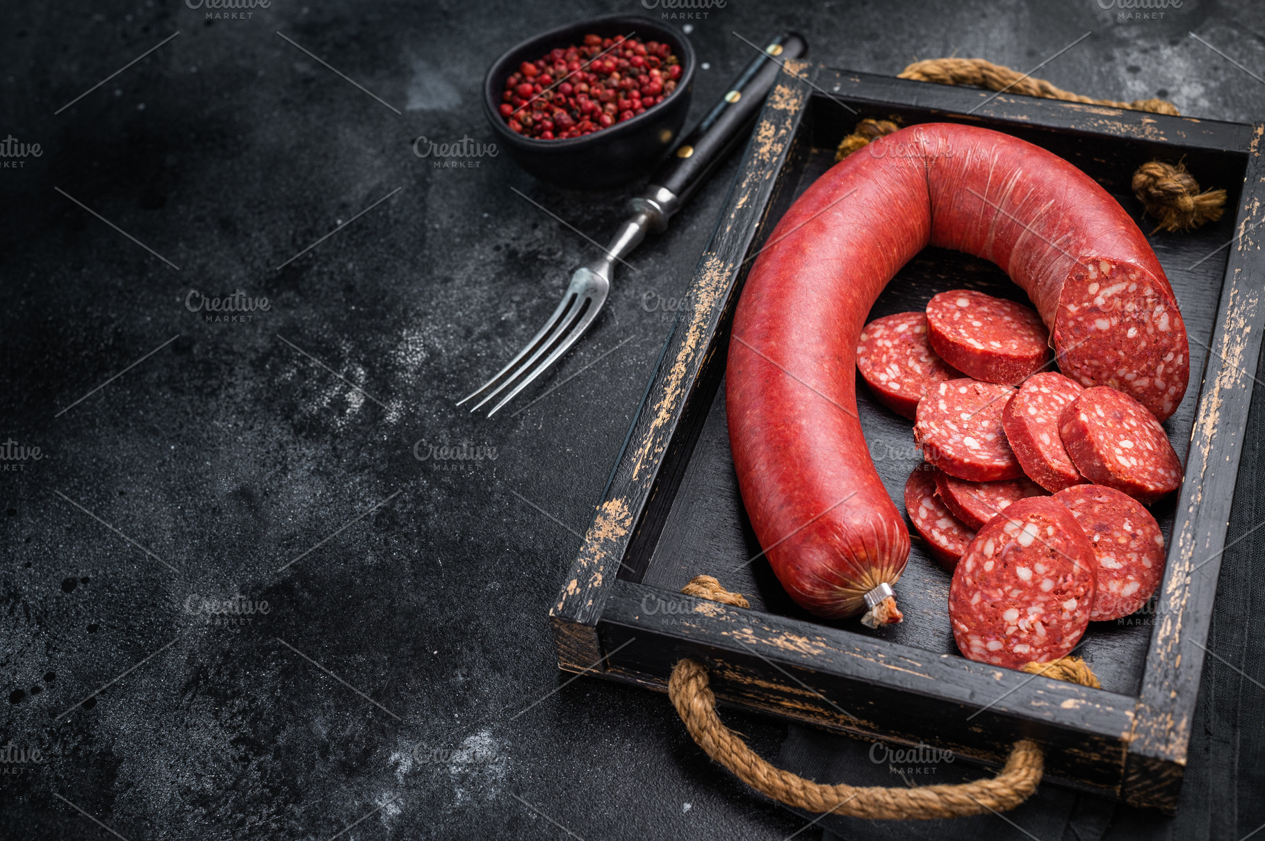 Sliced and whole Turkish sucuk (sujuk) in a rustic tray with a f, a Photo by composter-box@mail.ru