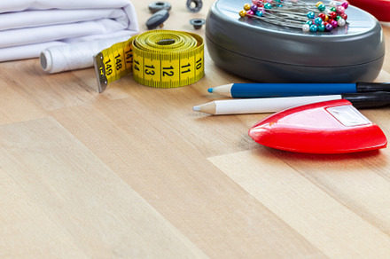 Cloth and various sewing accessories, spools and thread, on wooden table, squar, an Arts & Entertainment Photo by iuliia_n