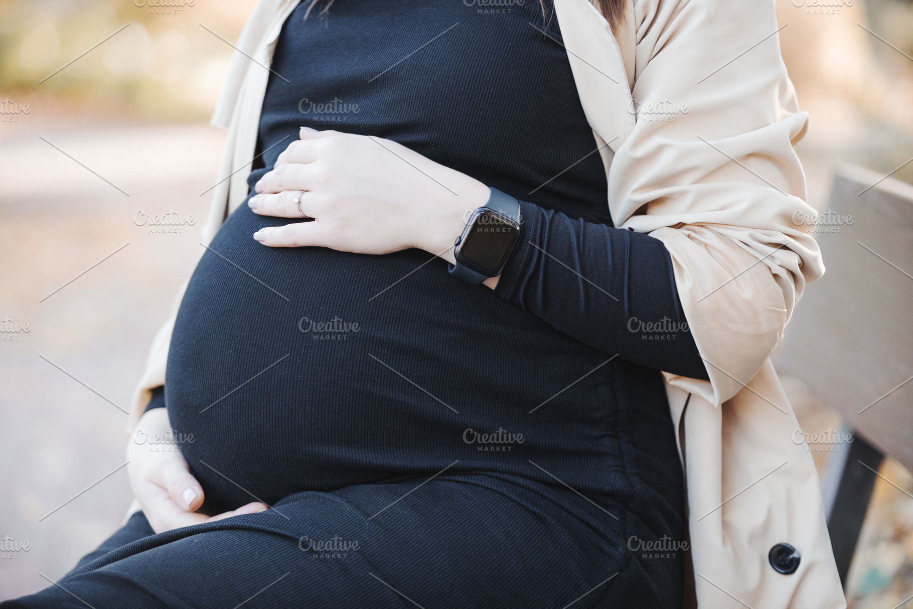 Pregnant woman outdoors touching bel, a Person Photo by Valeria Art