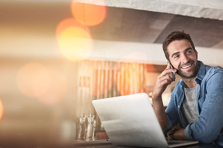 Phone call, laptop and man in coffee shop for remote work, client contact and online connection. Communication, business mockup and freelance male talking, networking and conversation on smartphone, a Photo by Peopleimages.com