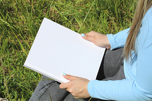 The girl is holding a book