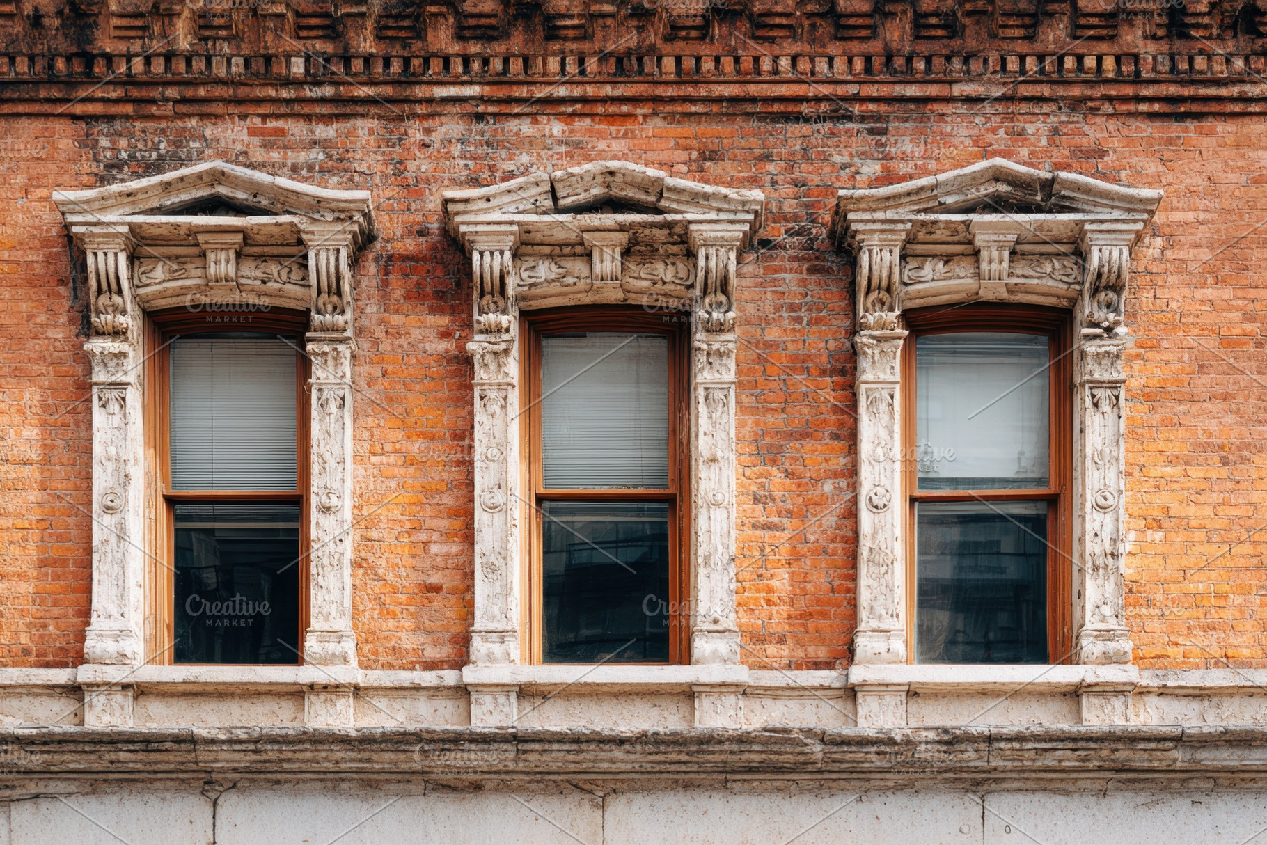 Ornate windows on a vintage brick facade, an Architecture Photo by AlyaAnd