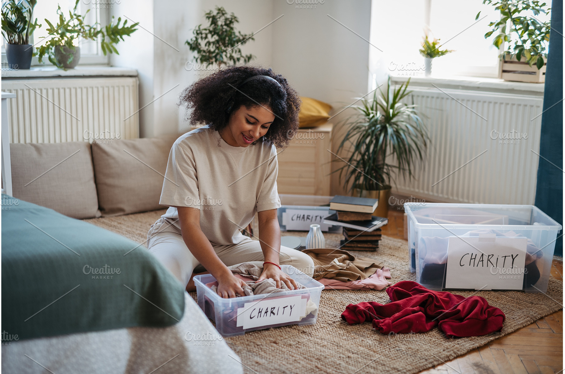 Young woman sorting wardrobe indoors, a Person Photo by HalfPoint
