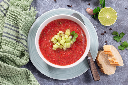 Cold soup Gazpacho garnished with cucumber and cilantro, in bowl, horizontal to, a Food & Drink Photo by iuliia_n