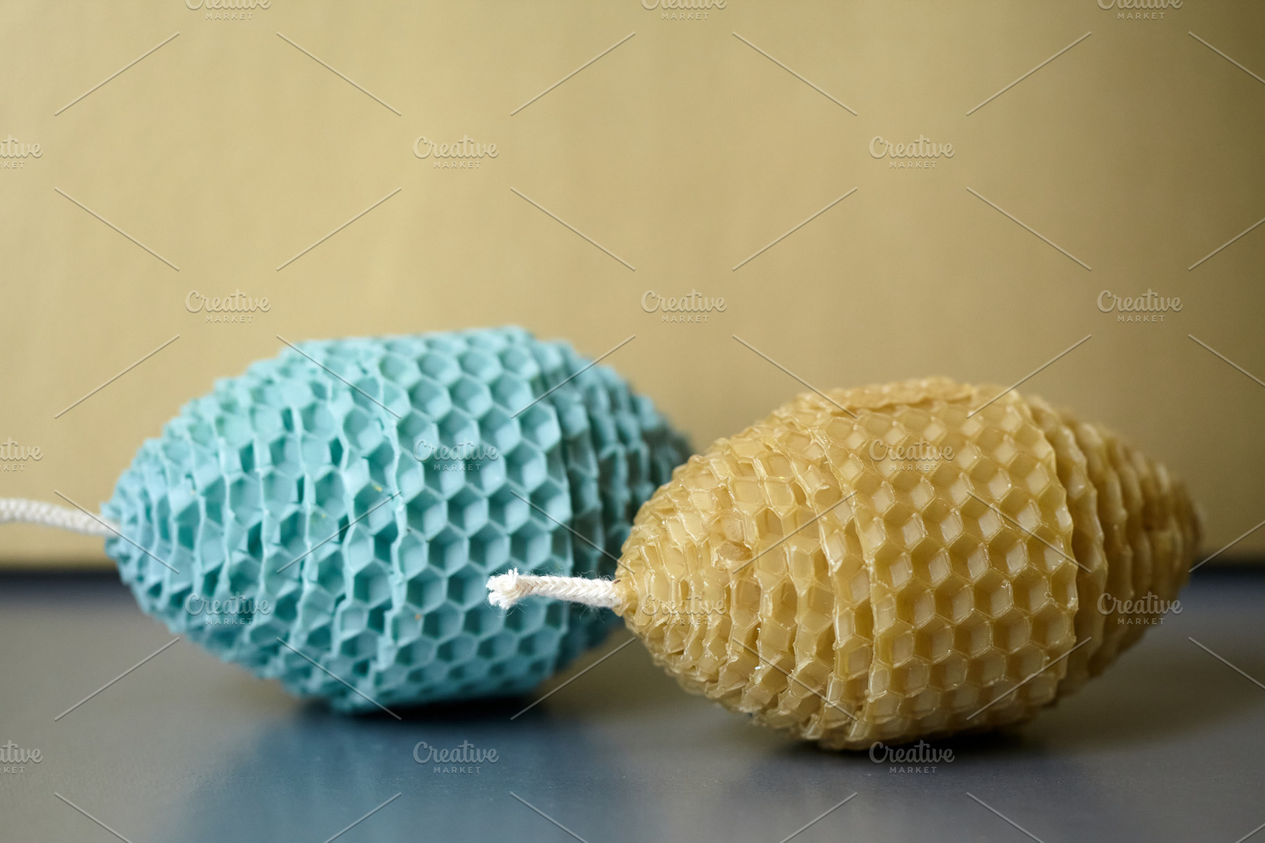 Two Easter Egg Shaped Candles Made of Natural Beeswax on a Neutral Background., a Holiday Photo by Rohan Photography