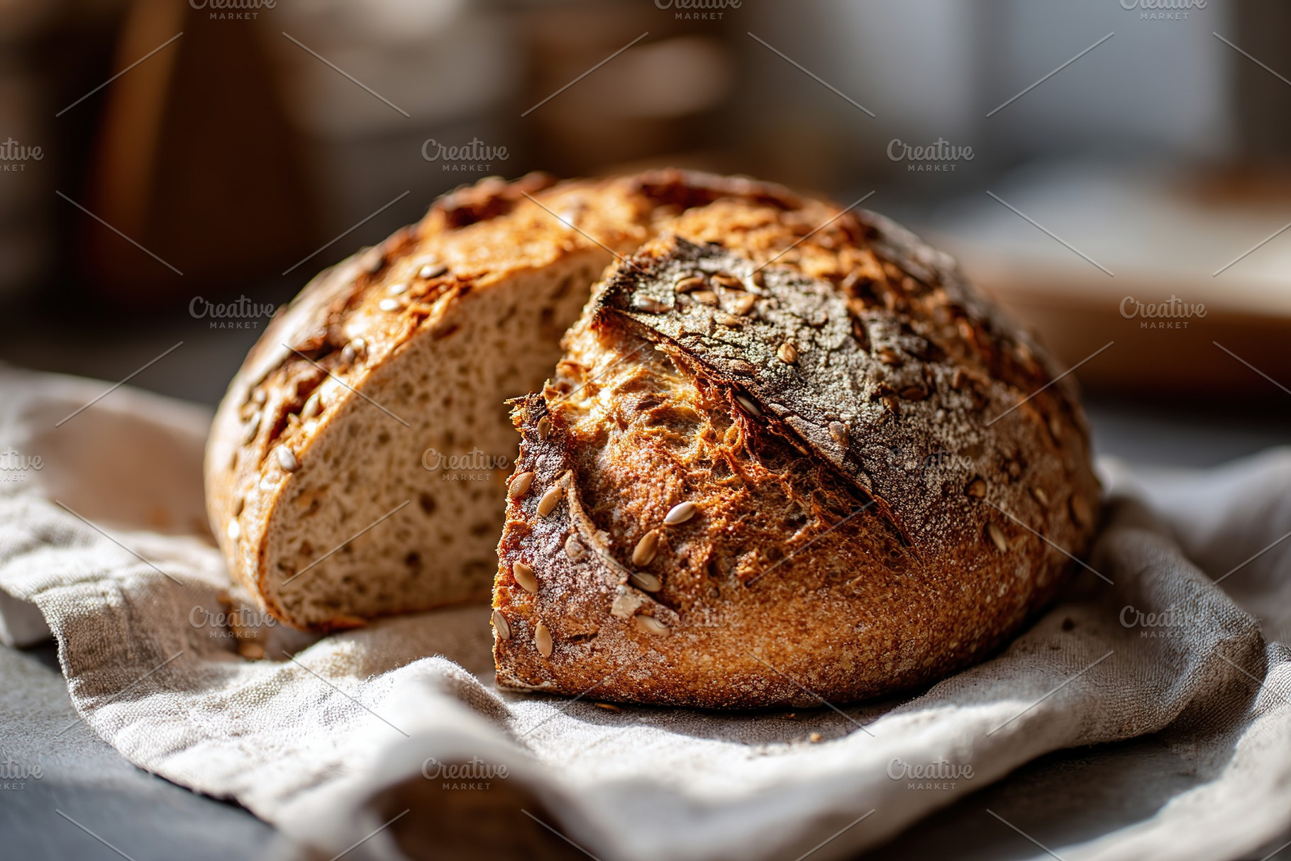 Freshly baked artisan bread resting on a cloth in a cozy kitchen setting, a Food & Drink Photo by AlyaAnd