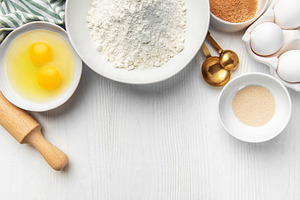 Baking ingredients on white wooden table for food preparation, a Food & Drink Photo by Olena Rudo