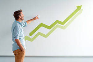 Presenter gestures towards a growing graph on the wall during a business meetin, a Business Photo by AlyaAnd