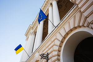Ukrainian and European Union flags on a neoclassical building in Lviv, a Photo by AS photostudio