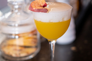 Served cocktail bright beverage frothy glass peach, a Food & Drink Photo by Photo Drive Studio