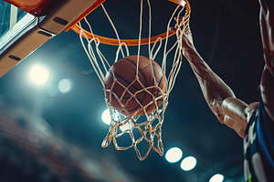 Basketball ball falling into the basketball hoop on basketball a, a Photo by AlyaAnd